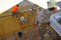 Screeding and compacting the base